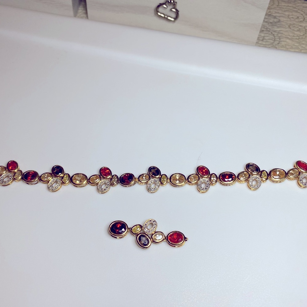 Gold plated bracelet and matching pendant.
